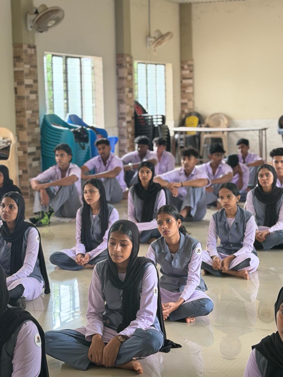 Students performing yoga asanas.